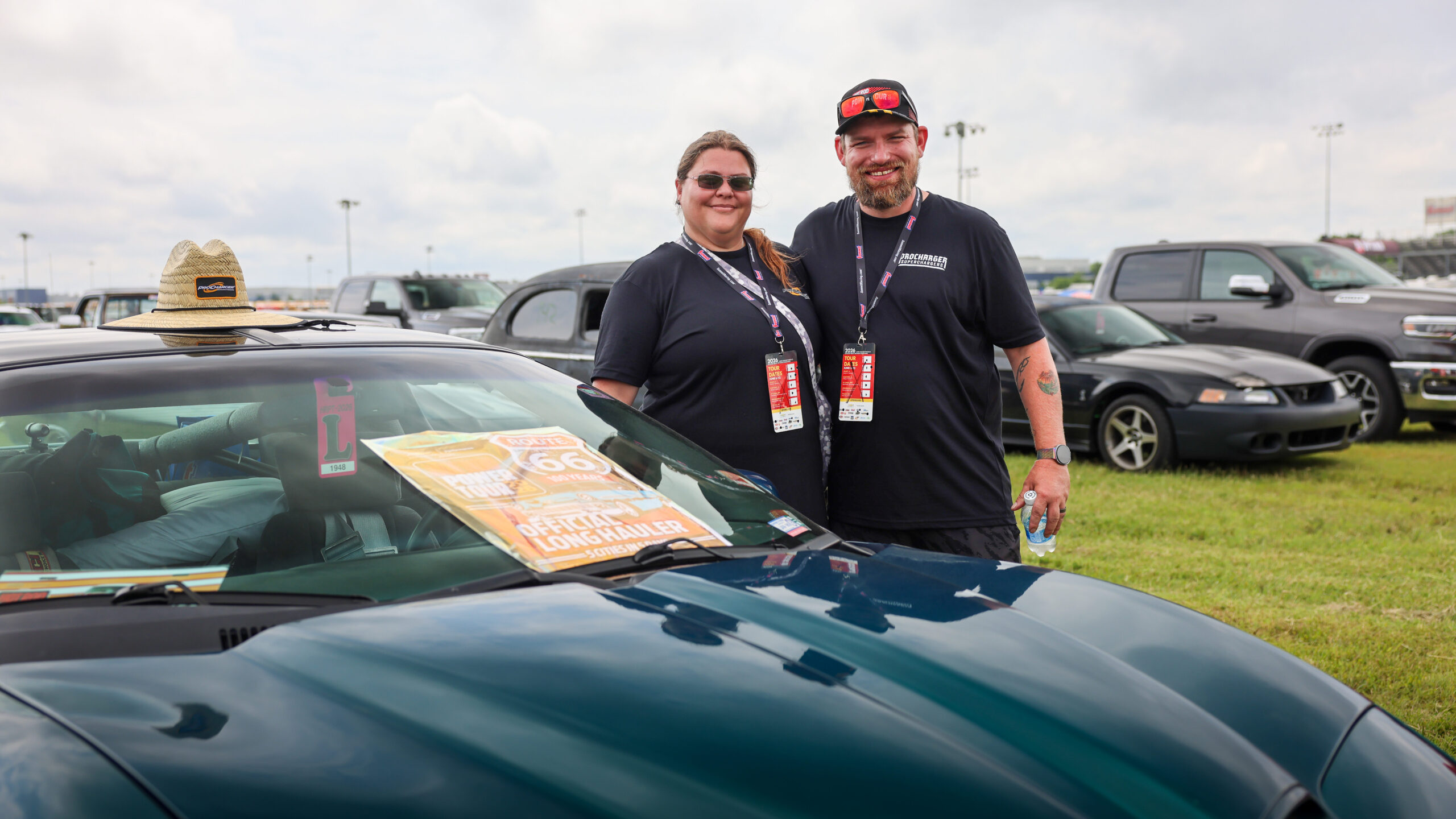 Tina and her husband standing next to the ProCharged F-Body