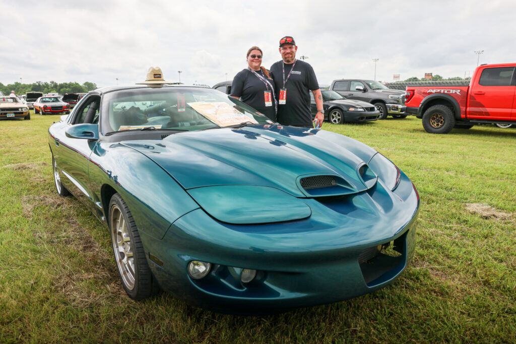 Tina and husband Stadning next to their ProCharged F-Body